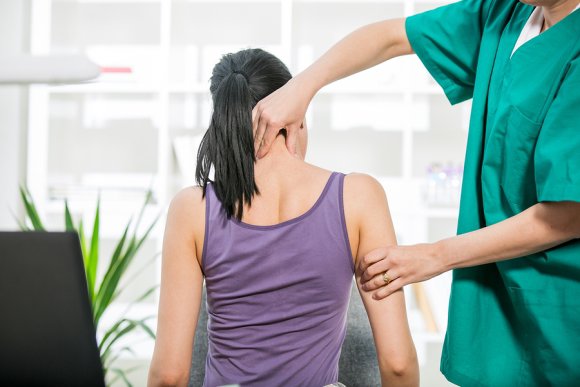 chiropractor massaging a lady patient