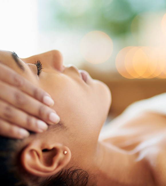 close-up of woman receiving massage on face